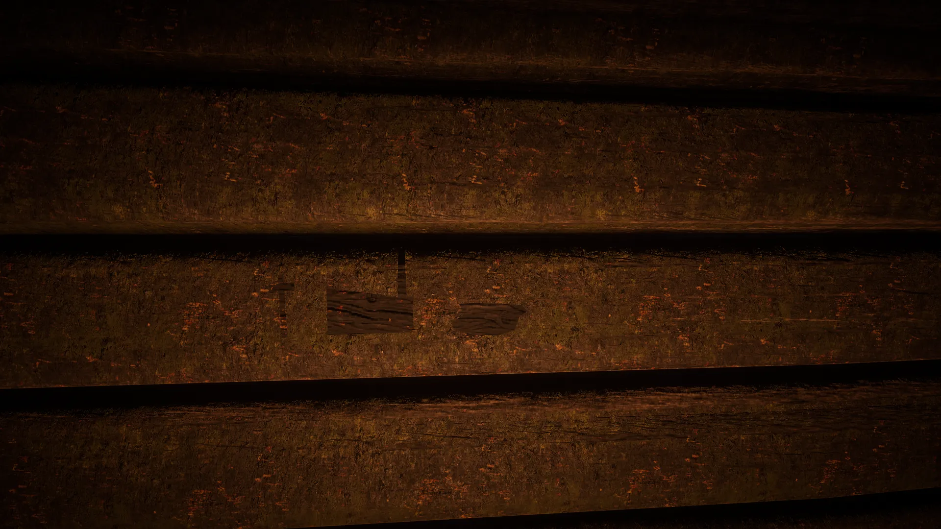 Three small pictograms scratched into a dark board at Fort Brennand.